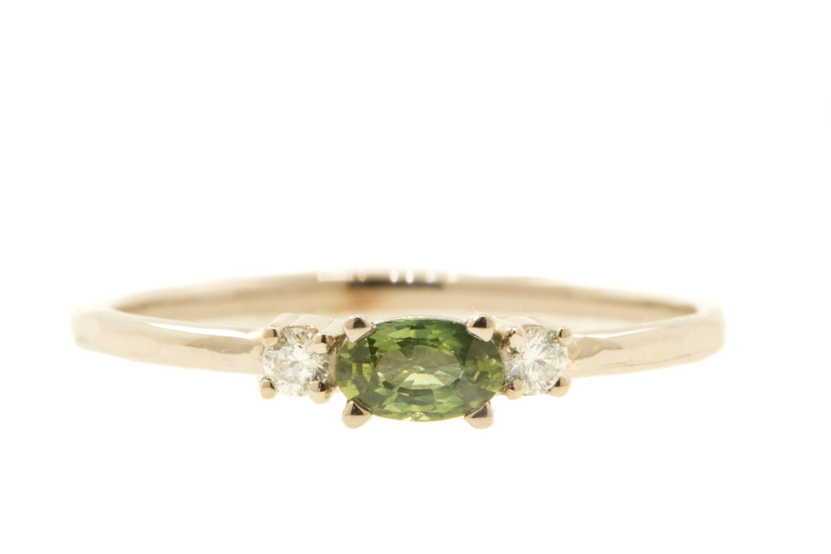 Handgemaakte en fairtrade fijne organische gouden ring met een groene ovale saffier en twee diamantjes