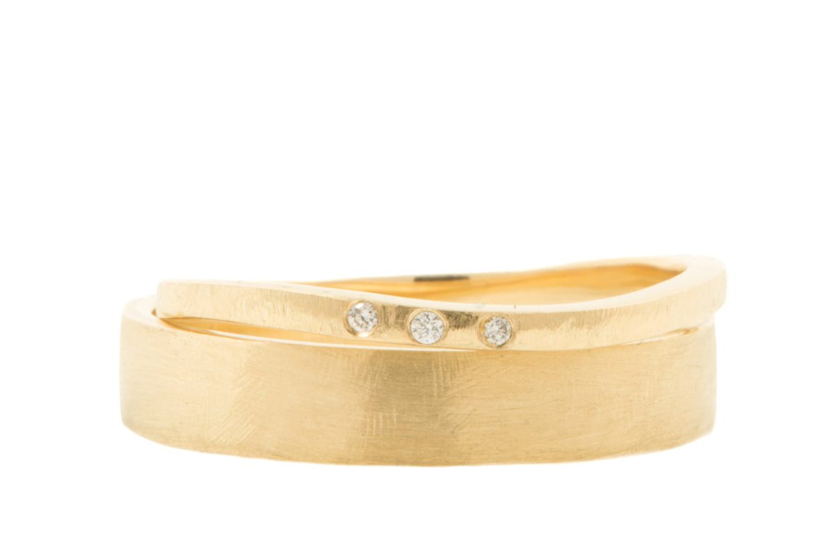 Handgemaakt en fairtrade. Set geelgouden trouwringen met drie diamantjes in de damesring.